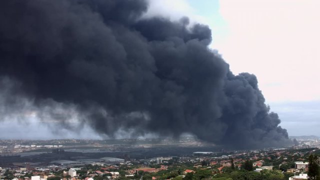 Time-lapse of black toxic fumes polluting the atmosphere on sunny day in Durban.