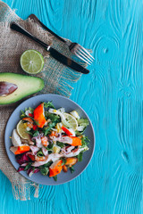 salad and pasta with seafood on a blue wooden background