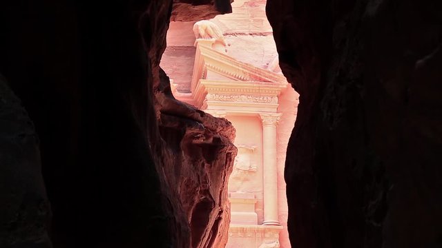 Al Khazneh or Treasury - Nabatean rock-cut temple of Hellenistic period of ancient Petra, historical and archaeological city in Jordan. View from Siq - long narrow passage, gorge that leads to Petra