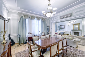 The interior of the spacious apartment is in light colors with a large dining table.