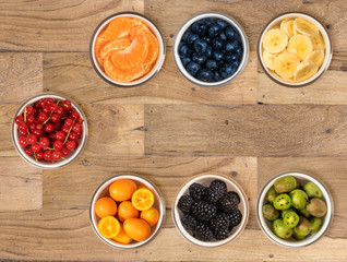 From above view of bowls of multiple fruits