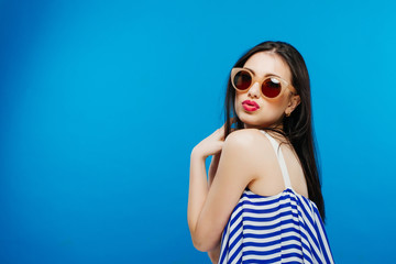 Colorful portrait of young attractive woman wearing sunglasses. Summer beauty and nail art concept
