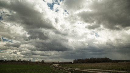 Fototapeta na wymiar Clouds over the field