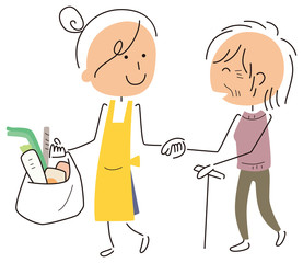 高齢者と買物をする女性