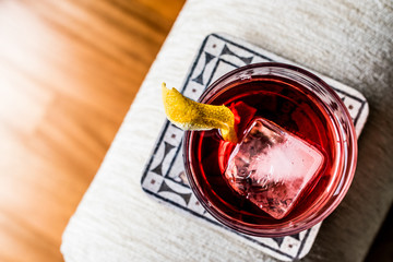 Negroni Cocktail with lemon peel and ice
