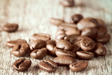 Brown coffee beans on wooden background