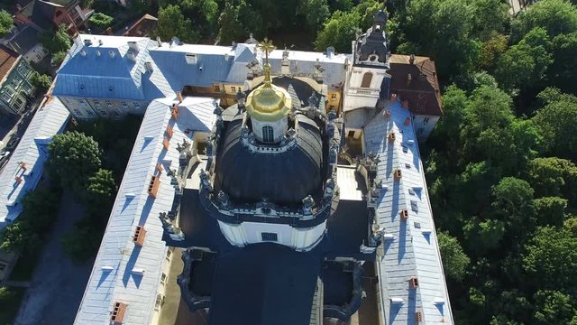AERIAL flight away from ancient church in Lviv. 4K