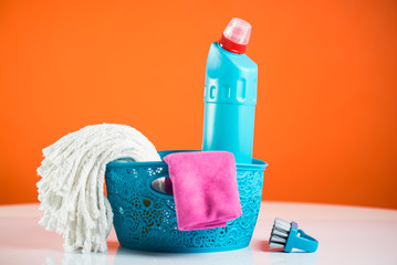 Spring cleaning concept with supplies, colorful background