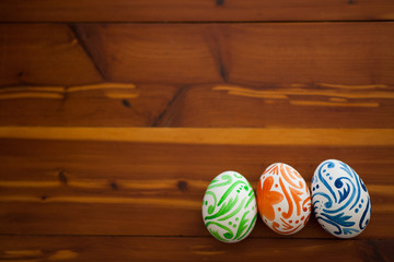 Easter eggs sitting on wooden table