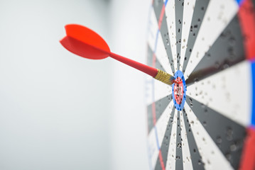 Close up of dartboard with dart arrows in center
