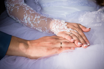 Bride holding hands in front of the dress