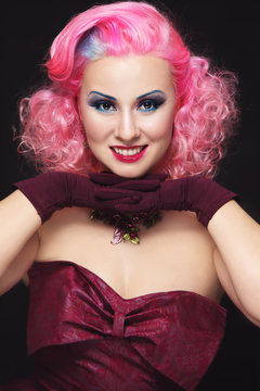 Smiling happy vintage beauty with pink curly hair and fancy make-up