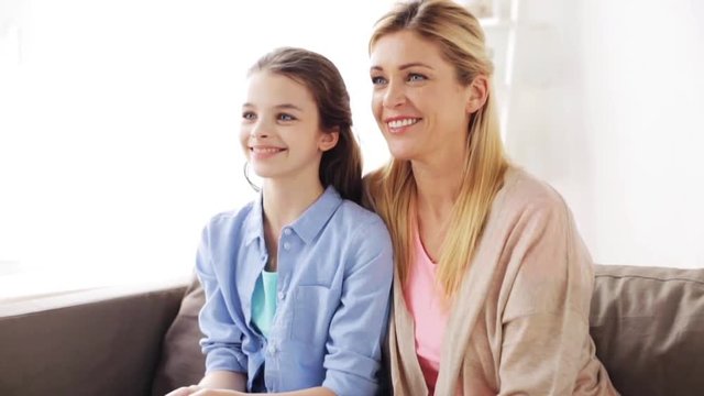 happy smiling mother and girl at home