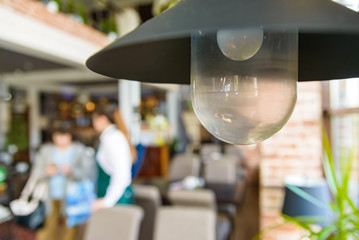 Close up modern lamp hangs in restaurant