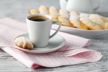 Icing lemon vanilla madeleine (shell-shaped cookies) on plate