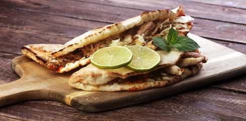 Delicious kebab sandwiches on wooden table