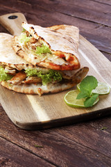 Delicious kebab sandwiches on wooden table