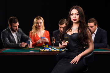 Young people playing poker at the table. Casino