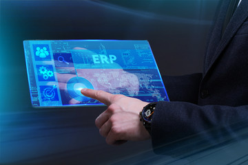 Business, Technology, Internet and network concept. Young businessman working on a virtual screen of the future and sees the inscription: ERP