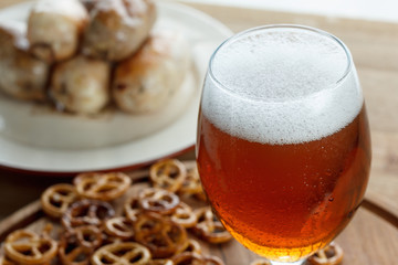 Beer glass with german pretzel and sausage