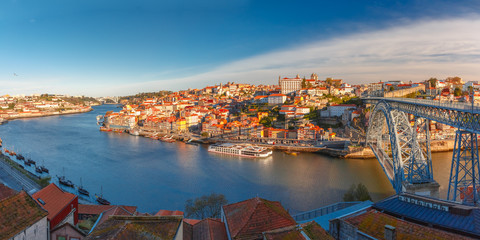 Picturesque panoramic aerial view of Old town of Porto, Ribeira and Dom Luis I or Luiz I iron bridge across Douro River in the morning, Portugal