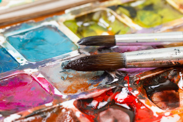 Set of watercolor paints and paintbrushes for painting