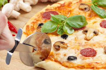 Hot pizza with cheese on a wooden table.