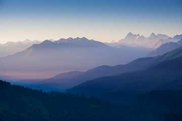 Fototapeta na wymiar The first rays of the sun illuminate the mountain in the Western Caucasus