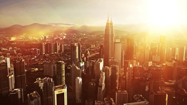 Orange sunrise. Aerial view of Kuala Lumpur city in Malaysia capital, tall buildings. Cinematic video of skyscrapers in big City.