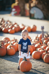 Fototapeta premium Happy little boy with pumpkin