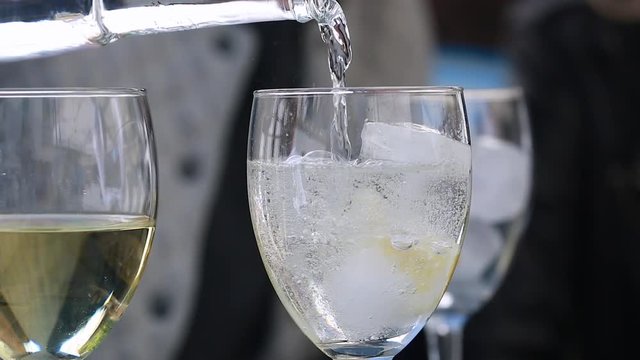 Pouring Cold Sparkling Water Into The Glass With Ice Cubes, Restaurant - HD Video
