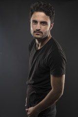 Caucasian guy wearing black T-shirt in studio 