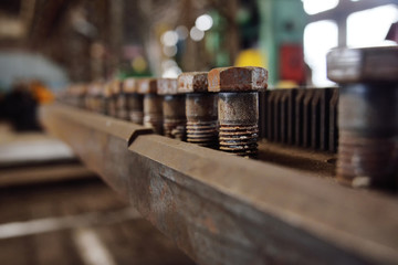 Production of bolts against the background of the plant. Heavy industry, plant, metal structures