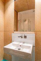 Wooden bathroom interior with washbasin