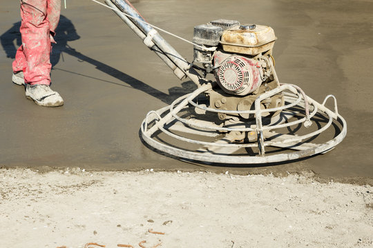 Working power trowel machine on a fresh concrete surface