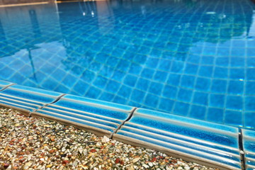 Swimming pool with stair and blue relaxing water