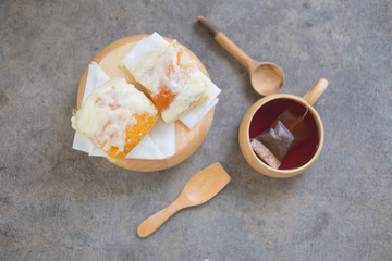 Dessert bread dusted with milk, sugar and butter and hot tea