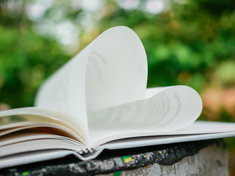 Open book with pages shaped like heart