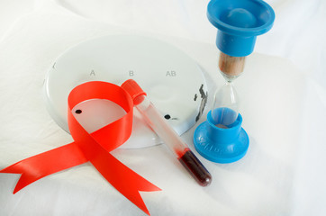Blood sampling and analysis in a biochemical laboratory on a light background. A plate with a...