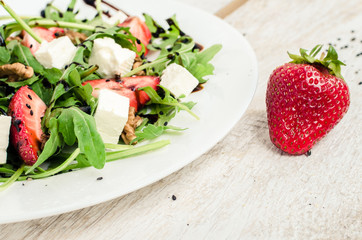 Fresh salad with arugula and strawberries