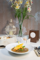 Onion soup on the table in a composition with a glass of wine and bread