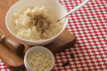 Brazilian dessert sweet canjica of white corn with pacoca sweet in bowl and towel. Festa Junina Party Brazilian Culture Concept Image.