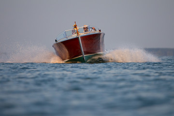 A wood powerboat starting to turn at high speed