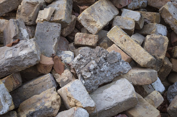Old bricks on construction site. Close-up of wreckage building brick wall.