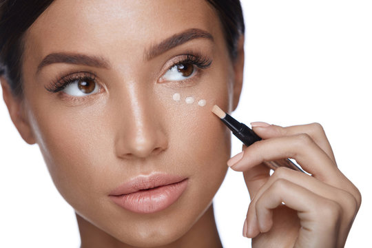 Beauty Woman Face Makeup. Female Applying Corrector Under Eyes