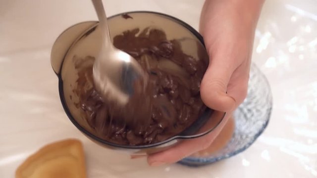 Woman's hands stirring the chokolate in the bowl