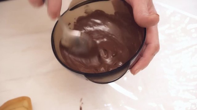 Woman's hands stirring the hot chokolate in the bowl