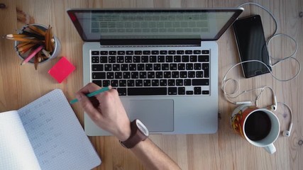 Businessman writes a plan what to do.