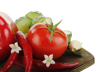tomatoes, peppers, cucumbers on hardboard isolated