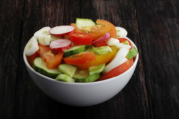 vegetables salad in plate on wooden background